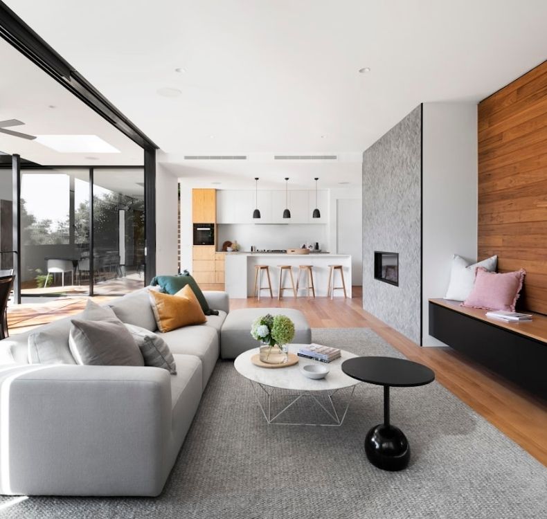 Bright open concept living room and kitchen with modern finishes large windows and hardwood floors
